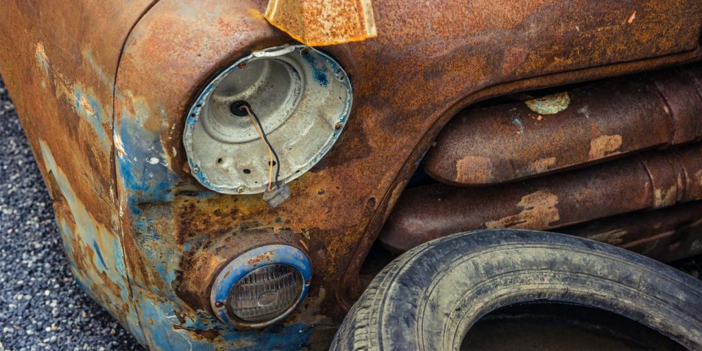 a rusty vintage car owned by a man who learned how to repair rust on a car