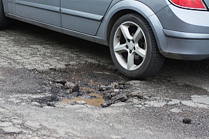 Car driving on pothole