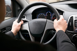 Hands on steering wheel in a car