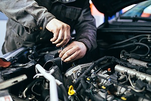 an auto worker repairing or restoring a car engine