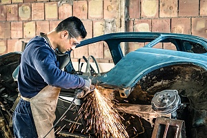 a person who knows where to start when restoring a car working in a garage
