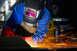 a person welding metal to his truck frame