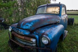  a blue truck before being worked on with some rust