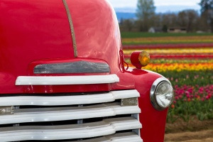 front of a red classic truck