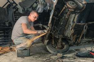 A mechanic restoring a classic car