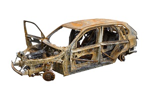 Burnt Out Car Isolated On White Background needing repairing a rusted auto frame