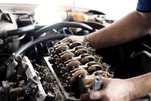 worker installing car engine