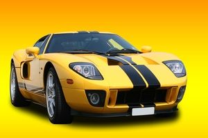 A yellow car with racing stripes
