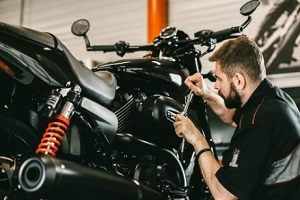 man working on motorcycle